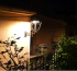 Nighttime outdoor wall light by a small porch (compact design, ideal for small spaces)